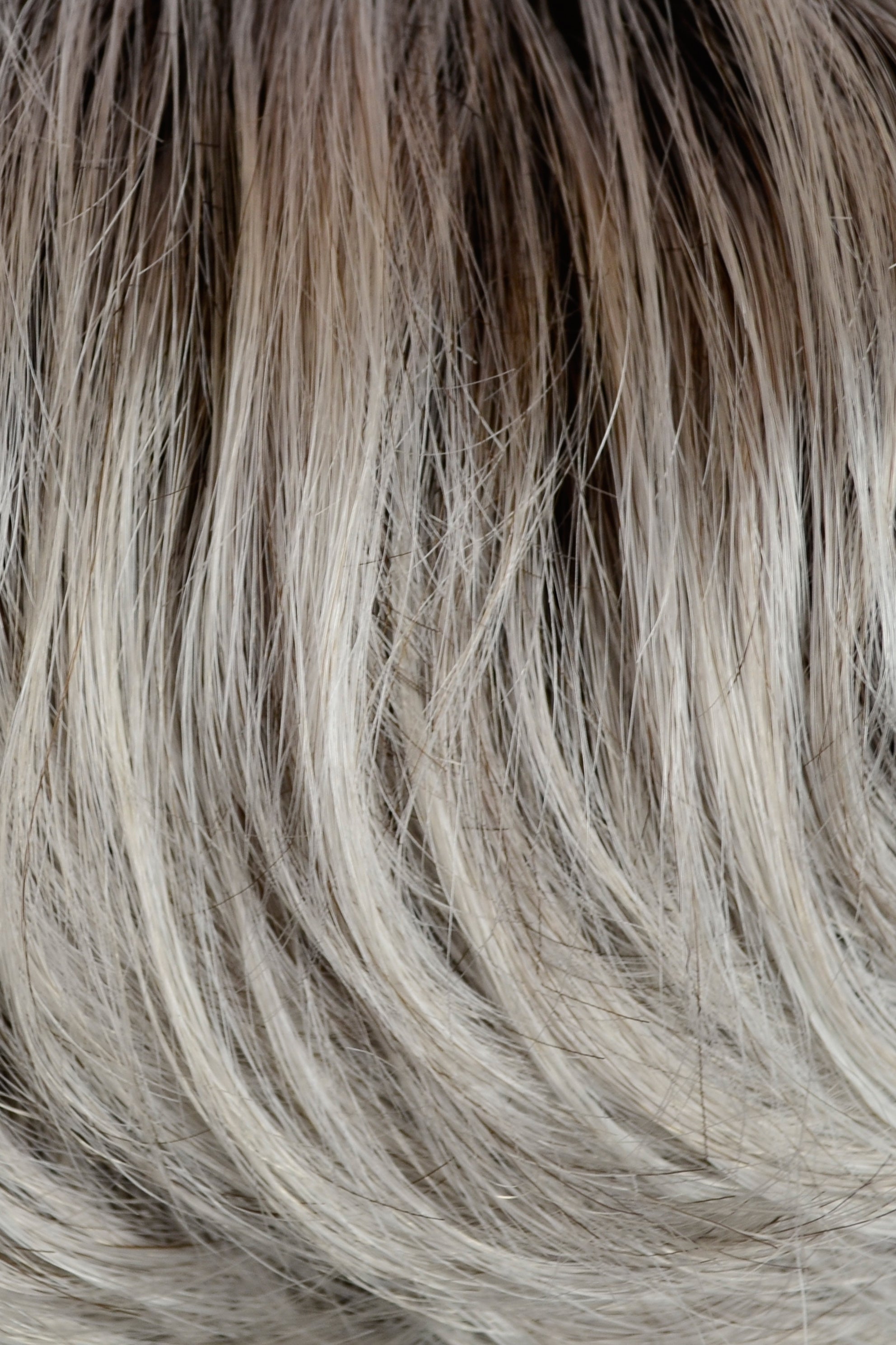 Gisela Mayer Magic Fresh in Light Grey Rooted, side view showing the contemporary grey shade on the modern short cut wig.