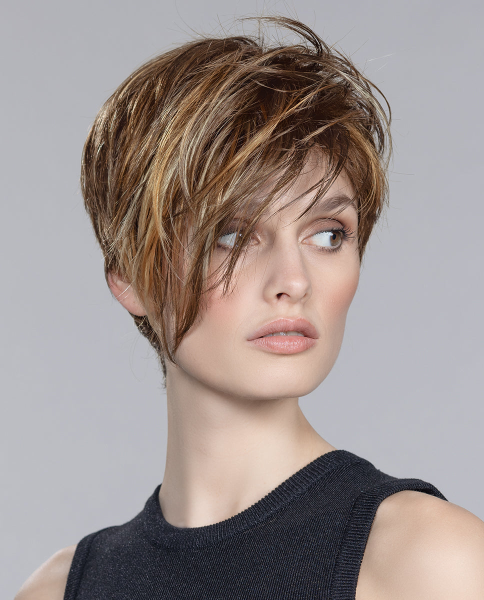 Shop the Disc Mono Part wig by Ellen Wille. A bold short layered cut with an asymmetrical fringe and realistic mono part, ideal for medical hair loss.