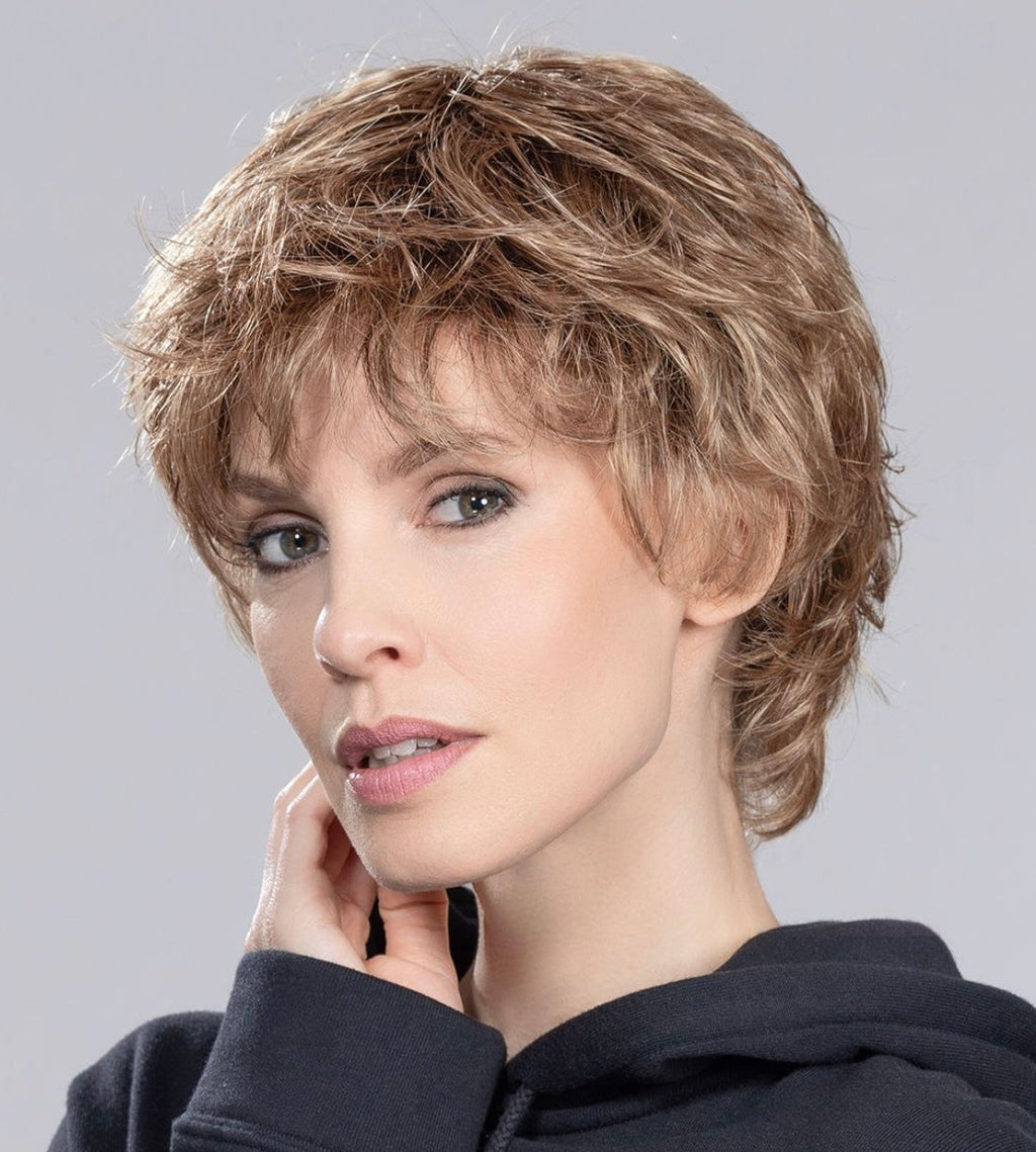 Keira wig by Ellen Wille, lifestyle view showing the short feathered cut and natural volume of the synthetic fiber.