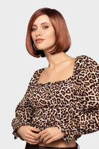 Next wig by Gisela Mayer, side view showing the mid-length angled bob with side piece and sleek synthetic style.