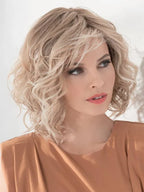 Eclat Deluxe in Sandy Blonde by Ellen Wille, three-quarter angle showing the warm sandy tones on the mid-length wig.