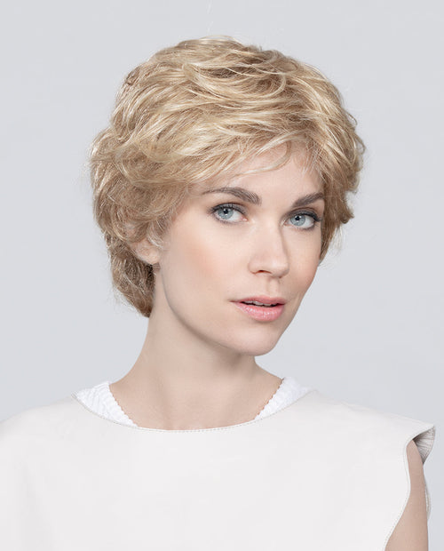 Front view of a woman wearing the Ellen Wille Alexis Deluxe wig, showcasing its subtle waves, natural volume, and elegant short cut.