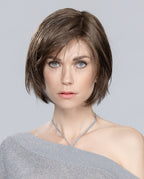 Front view of a woman wearing the Ellen Wille Amy Small Deluxe wig, showcasing its petite short bob cut, tapered ends, and side-swept fringe.