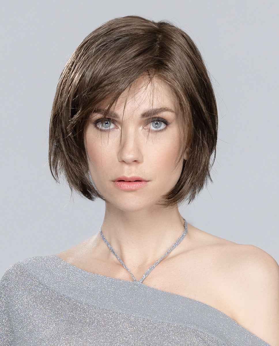 Front view of a woman wearing the Ellen Wille Amy Small Deluxe wig, showcasing its petite short bob cut, tapered ends, and side-swept fringe.
