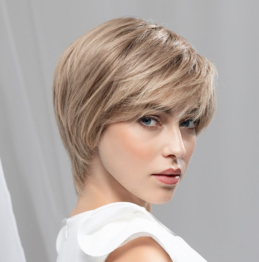 Front view of a woman modeling the short, layered Ellen Wille Award Deluxe human hair wig, highlighting its elegant shape and face-framing fringe.