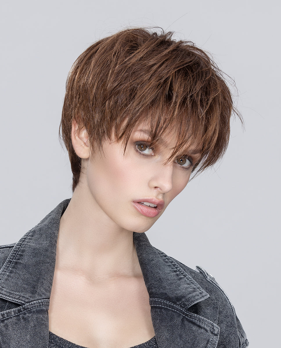 Front view of a woman wearing the Ellen Wille Beat short wig, showing its textured tapered cut and modern brow-grazing fringe.