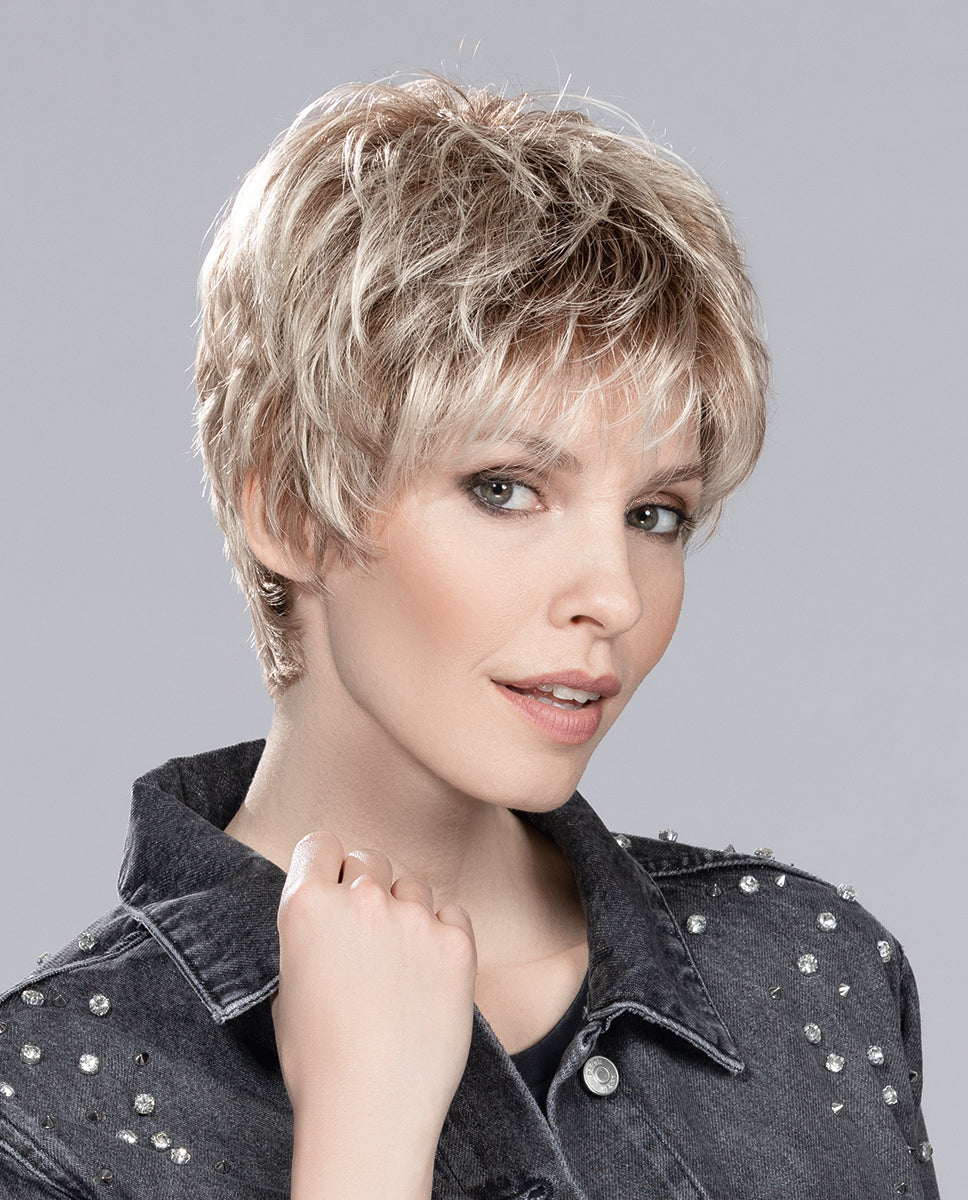 Profile view of a woman wearing the Ellen Wille Bo Mono ultra-short pixie wig, showing the tapered crown and natural volume at the back.