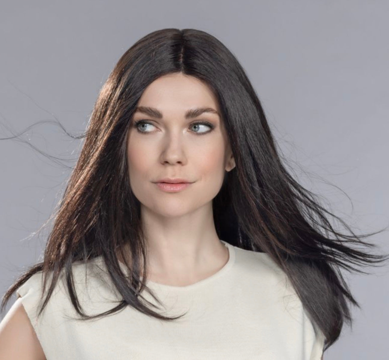 Front view of a woman modeling the long, layered Ellen Wille Boheme human hair wig, highlighting its natural flowing movement and seamless lace front hairline.
