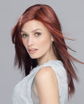 A woman wearing the long, sleek Ellen Wille Code Mono synthetic wig, showcasing its natural parting and extended lace front hairline.