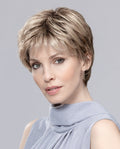 A woman wearing the sophisticated Ellen Wille Estate Mono pixie wig, highlighting its realistic monofilament top, extended lace front hairline, and sleek gray color.