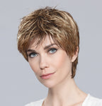 Profile view of a woman wearing the Ellen Wille Fair short wig, showcasing its sporty tapered neckline and elegant wispy fringe.