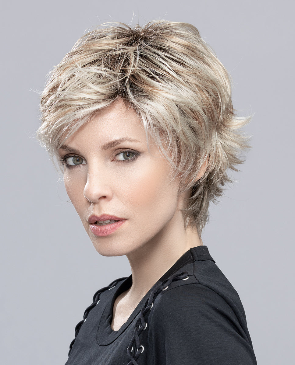 Profile view of a woman wearing the short Ellen Wille Flip Mono wig, showcasing its texturized flipped-out layers, voluminous back, and clean neckline.