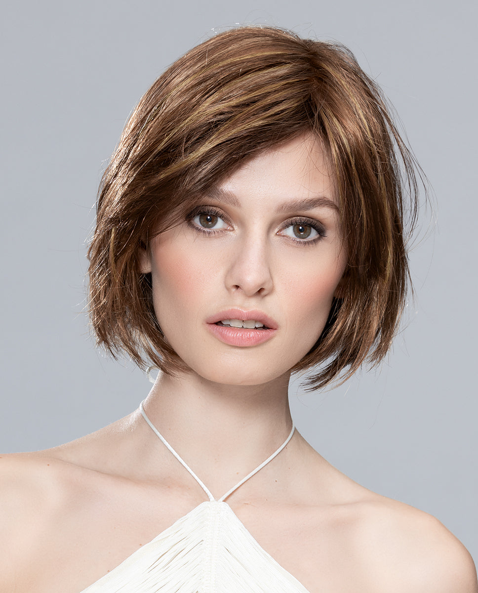 A woman modeling the Ellen Wille Fresh wig, showcasing its layered bob cut, voluminous back, and modern side-swept fringe.