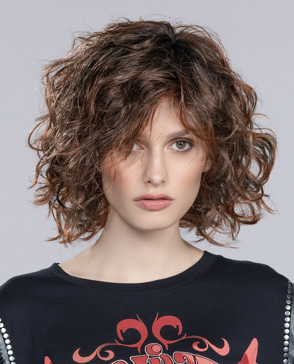A woman modeling the mid-length Ellen Wille Girl Mono Large wig, highlighting its comfortable large cap fit, texturized layers, and natural lace front.