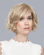 Front view of a woman wearing the Ellen Wille Like Mono Part wig, showcasing its elegantly tapered short bob cut and stylish side-swept fringe.