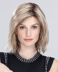 A woman modeling the upgraded shoulder-length Ellen Wille Limit Mono Part wig, showcasing its face-framing layered fringe and invisible extended lace front hairline.