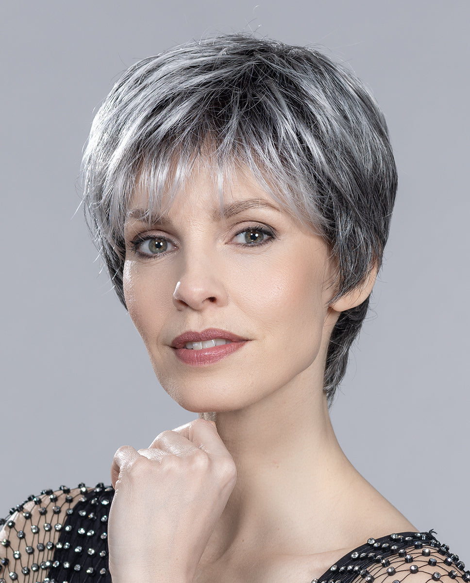 Profile view of a woman wearing the Ellen Wille Love Comfort short wig, showcasing its sporty texturized layers, clean flat nape, and natural volume.