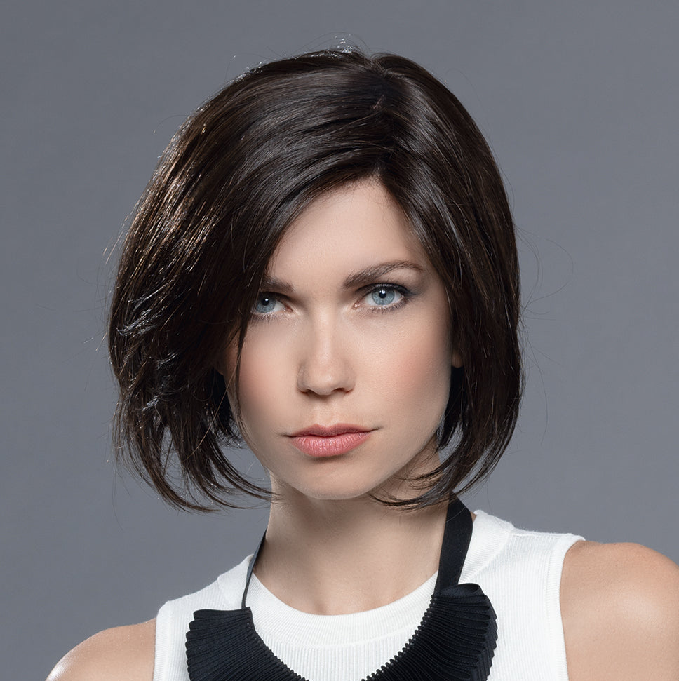 Back view of a woman modeling an Ellen Wille mid-length structured bob wig, highlighting the clean, precision-cut neckline and smooth layered style.