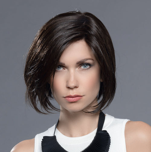 Back view of a woman modeling an Ellen Wille mid-length structured bob wig, highlighting the clean, precision-cut neckline and smooth layered style.