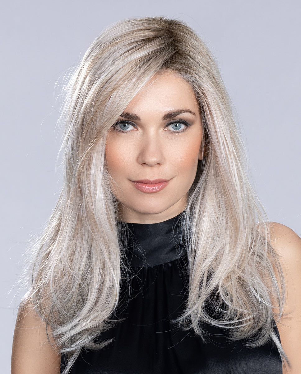 Front view of a woman wearing the long Ellen Wille Music Comfort wig, highlighting its tapered face-framing layers, natural fluid movement, and premium cap.