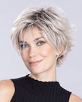 A woman modeling the Ellen Wille Relax Large short wig, highlighting its comfortable large cap fit, texturized tapered layers, and natural fluid movement.