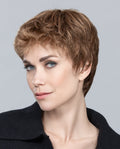 Profile view of a woman wearing the Ellen Wille Risk Large short wig, showcasing its sporty boy cut, closely cropped layers, and comfortable large cap fit.
