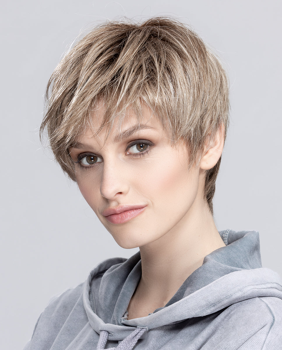 A woman modeling the sleek, short Ellen Wille Seven wig, showcasing its modern straight bob cut, smooth texture, and natural parting line.