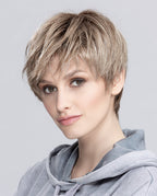 A woman modeling the sleek, short Ellen Wille Seven wig, showcasing its modern straight bob cut, smooth texture, and natural parting line.
