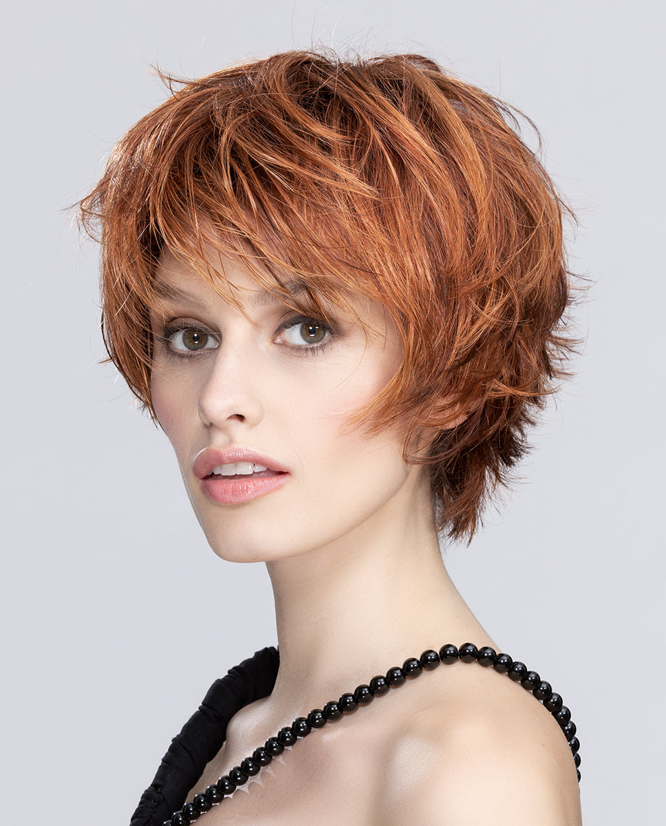 A woman modeling the short Ellen Wille Sky wig, highlighting its dynamic tapered layers, modern tousled messy-hair styling, and youthful silhouette.