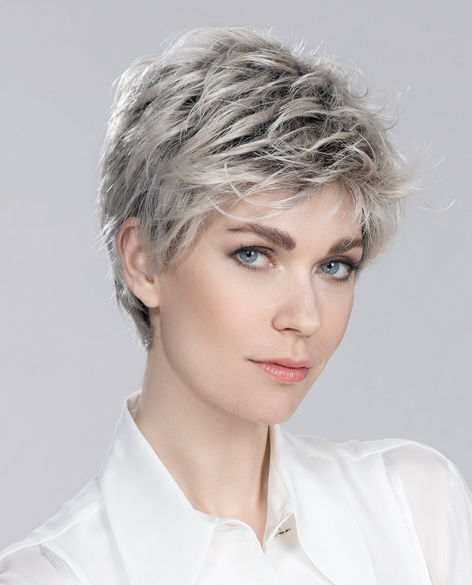 Front view of a woman modeling the Ellen Wille Spring Hi wig, highlighting its bold short pixie cut, texturized crown volume, and modern lightweight layers.