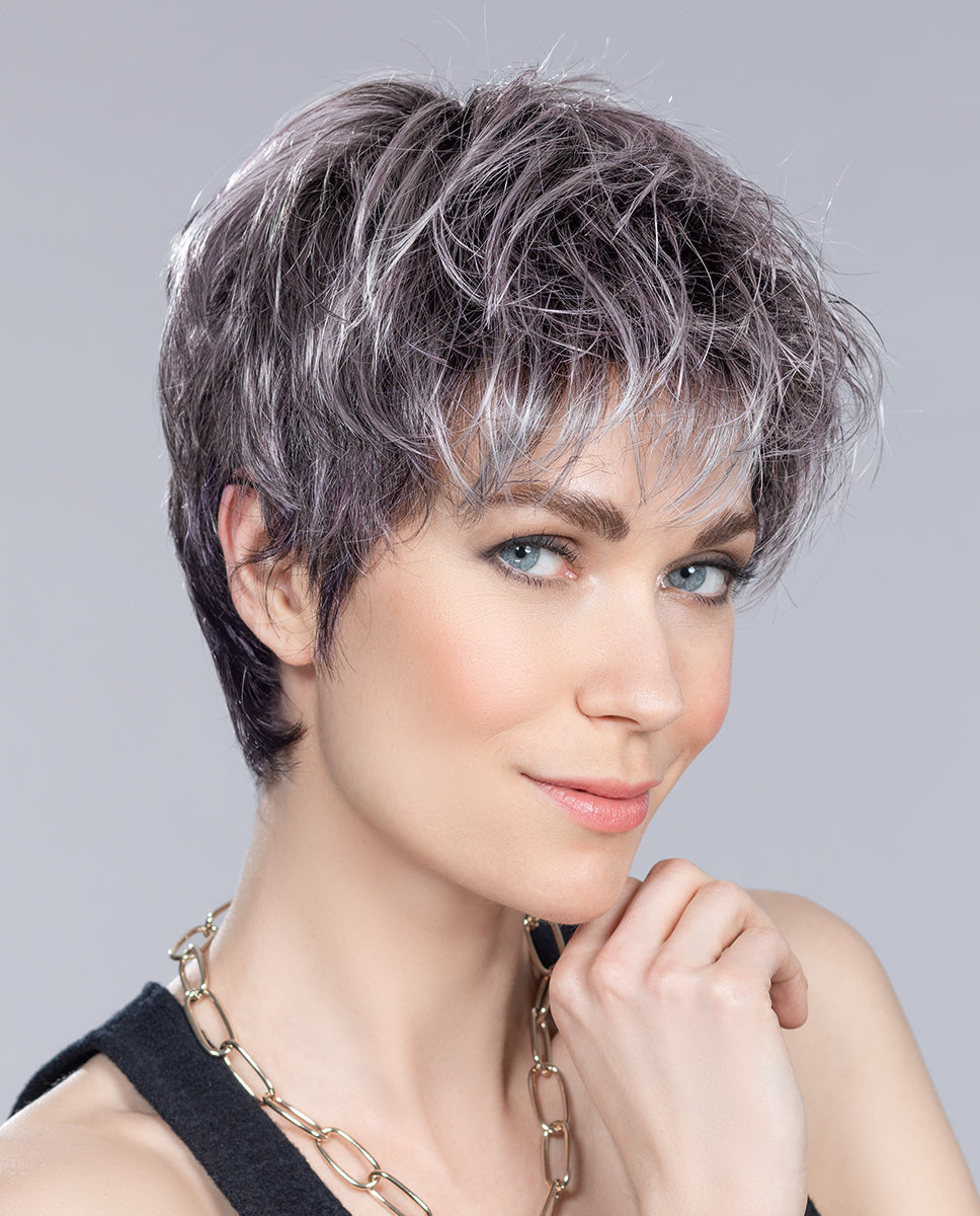 Side profile view of a woman modeling the Ellen Wille Stop Hi Tec wig, showcasing its modern tapered layers and natural built-in volume at the back.
