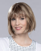 Front view of a woman modeling the Ellen Wille Sue Mono wig, showcasing its classic straight bob cut, blunt front bangs, and realistic monofilament top.