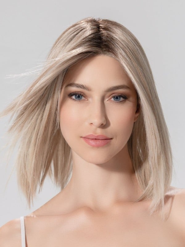 Ellen Wille Treasure Soft in Pearl Blonde Rooted, three-quarter view showing the delicate pearl tone on the mid-length heat-resistant wig.