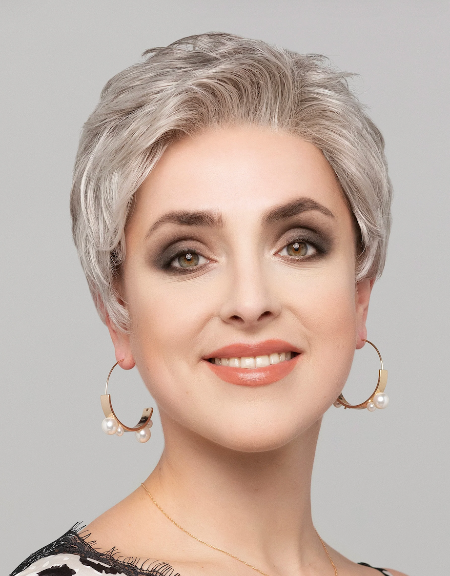 Front view of a woman wearing the Shorty Lace Small synthetic wig by Gisela Mayer, showcasing its short, voluminous cut designed for small head sizes.